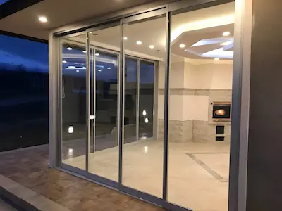 Modern terrace enclosed with SkyFold sliding glass system from Limoncello Pergola